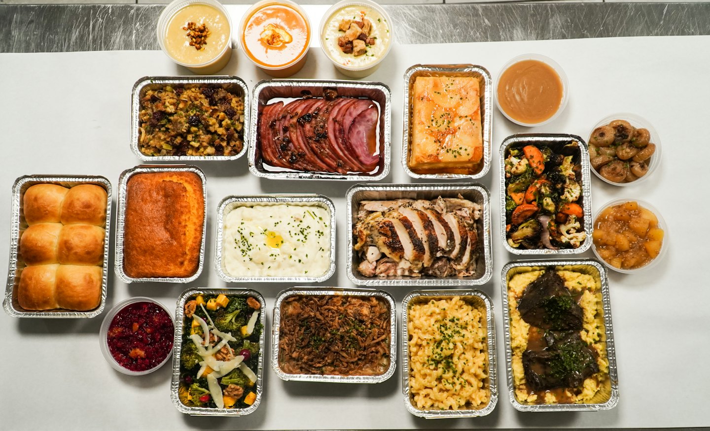 Gourmet takeout containers filled with prepared meals.