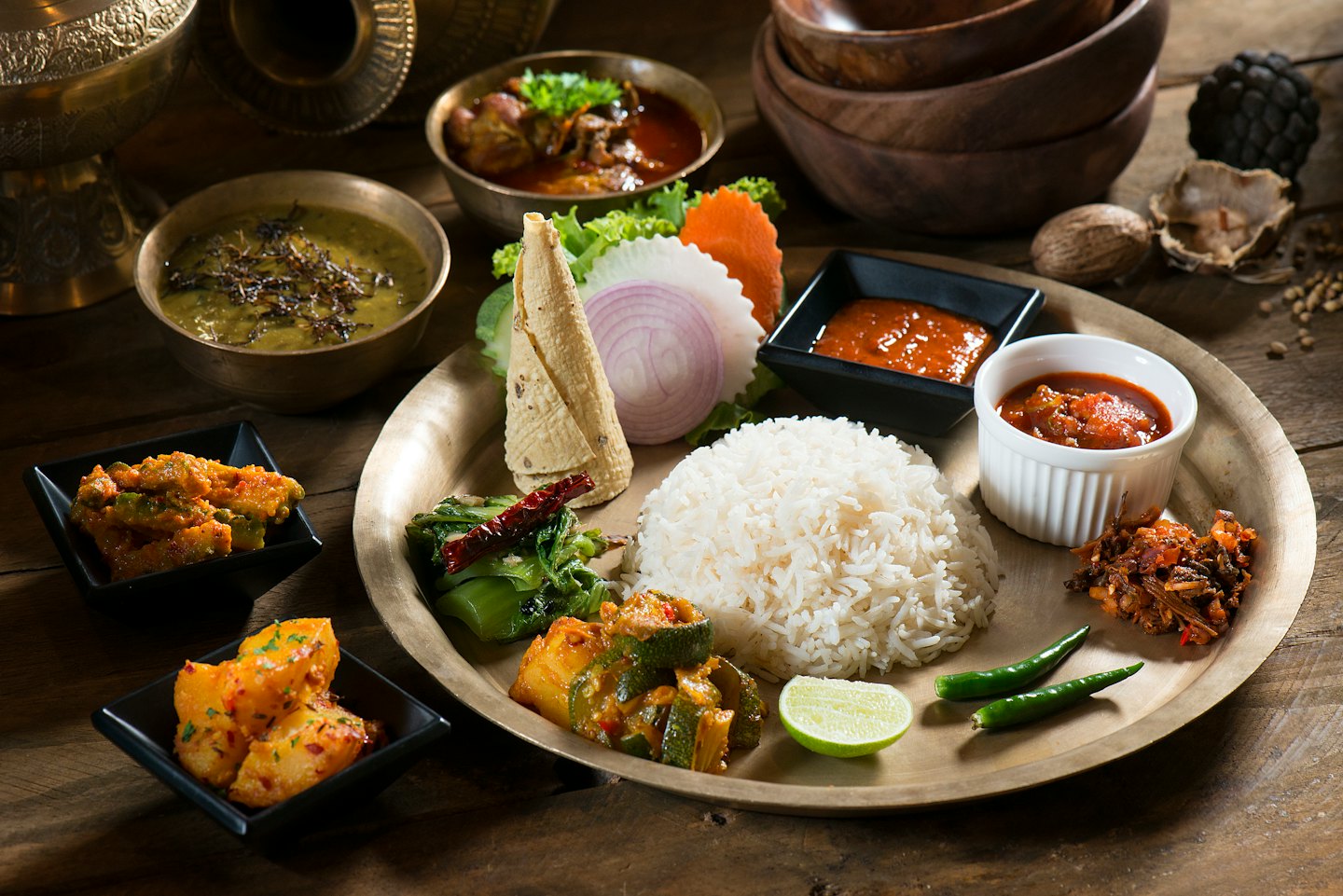 Traditional meal served on a large brass plate.