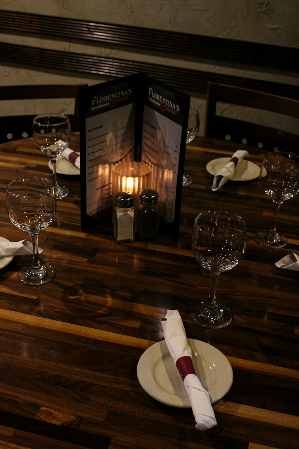 Restaurant table set for two with a candle.